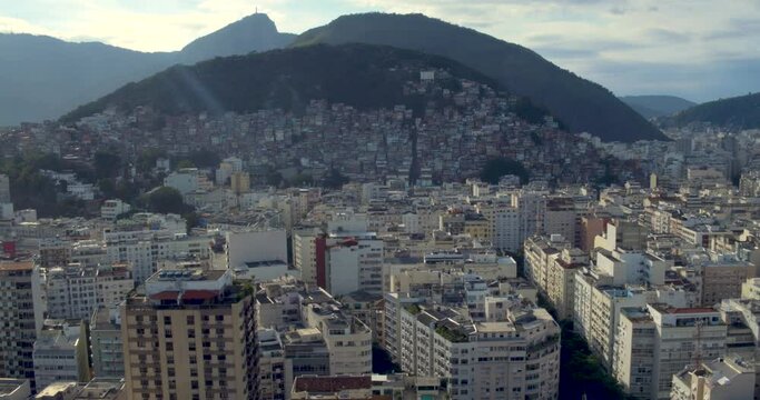 Cantagalo Hill slums behind the luxury paradise Copacabana Beach in Rio de Janeiro. Aerial drone shot.