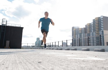 Fitness, workout, sport, lifestyle concept. Middle-aged man running in the city