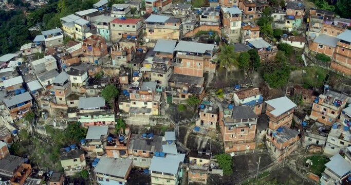 Morro dos Prazeres impoverished community in Rio de Janeiro. Aerial birds eye view, panning to reveal the city.