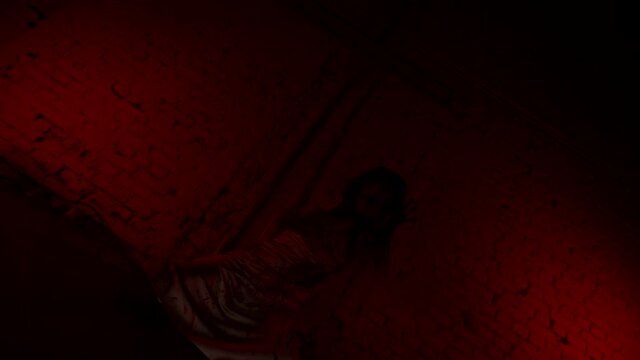 Ritual devil dance girl in blood on the background of the cross. Halloween party