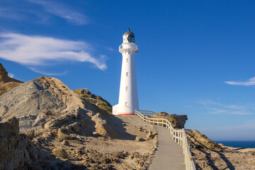 Walkway to Castlepoint Lighthouse in morning sunlight, New Zealand