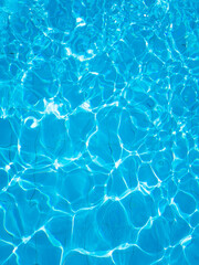 Fototapeta na wymiar Background of rippled water in swimming pool . Blue ripped water in swimming pool