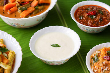 Onam sadhya , Vishu traditional South Indian vegetarian curry side dish of rice curd , Yogurt Moru curry sambar  ginger pickle Kerala , India , Sri Lanka, coconut oil, Indian spices cooking Pongal