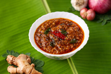 Injipuli , Puli Inji curry ginger pickle for Onam Sadhya Vishu vegetarian food on banana leaf. sweet and sour pickle made of ginger, tamarind,  jaggery in Tamil Nadu, Kerala South India , Sri Lanka.