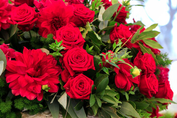 Big floral decoration with red roses, peony, dahlia and green branches of laurel tree. Party bouquet. Background picture. Wedding decor. Congratulation for a sweetheart. Mens bouquet. Corporate party