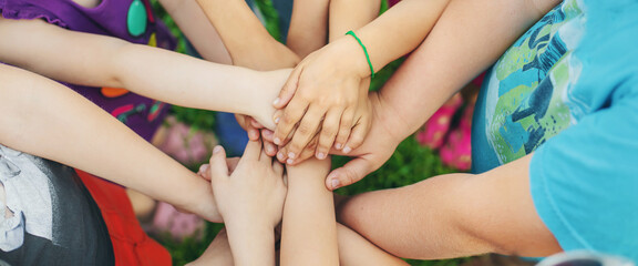 Children's hands together, street games. Selective focus.