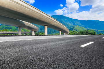 Fototapeta premium Asphalt road and green mountain natural landscape.