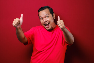 Fototapeta premium Portrait of happy asian man showing thumbs up