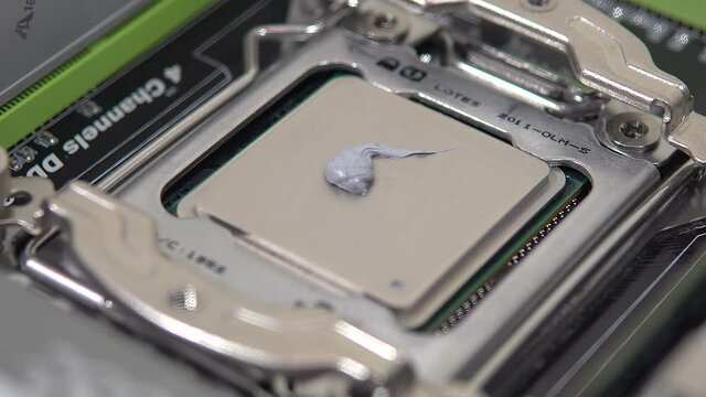 The repairman smears thermal grease on the main processor. Home PC Maintenance and Upgrades