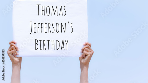 Thomas Jefferson's birthday with banner in hand in sky background