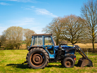 A farm tractor rests up after a day’s work on agricultural land surrounding the historic market...