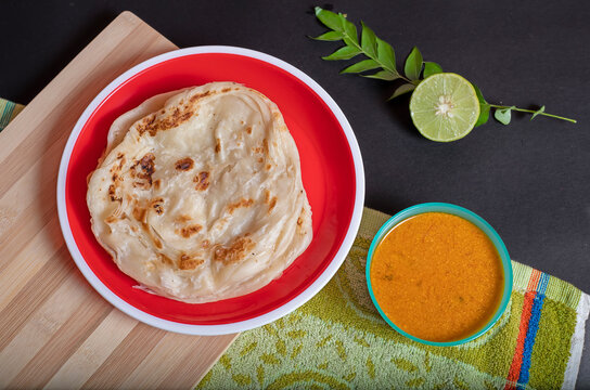 Homemade Kerala parotta with chicken gravy in a South Indian dish
