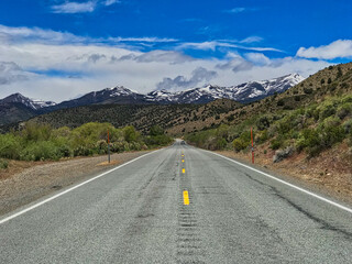 Lonely asphalt road through the mountains in Nevada, USA