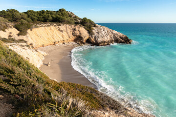 Obraz premium Beach and rocky coast with turquoise color sea in Sitges, Spain