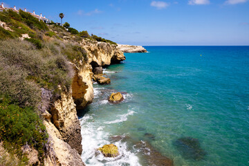 Fototapeta na wymiar Rocky bluff coastline with turquoise color sea, Tarragona, Spain