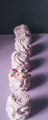 Fresh marshmallows on a purple background. Zephyr, meringue. The concept of home-cooked food. Minimalism, top view, flat lay