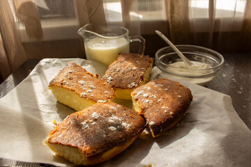 basque cheesecake on the table with sour cream and milk
