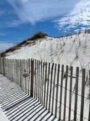 Fototapeta premium White sand dunes and fence at Norriego Point Florida 