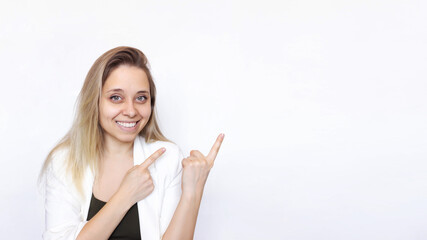 A young caucasian happy smiling successful blonde woman in a white jacket indicate copy empty blank space for text with two hands isolated on white background. Businesswoman presenting product. Banner