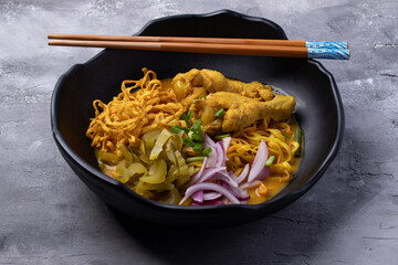 Khao Soi Recipe, Northern Style Curried Noodle Soup with Chicken in a black plate.