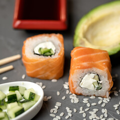 Sushi Philadelphia rolls with salmon and avocado. Asian or Japanese food, Oriental cuisine. Close up shot. Soft focus.