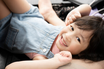 Obraz na płótnie Canvas Asian smiling girl happy in denim bib tops, fun leisure concept on summer vacation