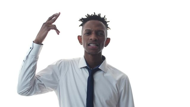 Tired black man in an office suit makes a gun gesture with hand and shoots at head. Office black man shoots hand into the temple.