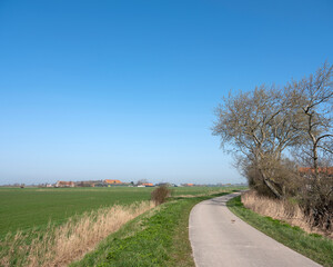 country road and farms on countryside of walcheren near middelburg in dutch province of zeeland