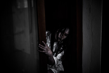 Portrait of asian woman make up ghost face with blood,Horror scene,Scary background,Halloween...