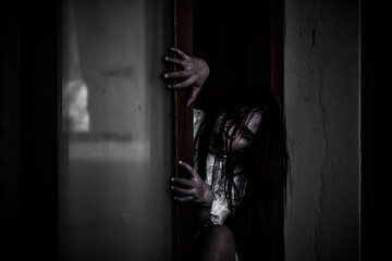 Portrait of asian woman make up ghost face with blood,Horror scene,Scary background,Halloween...