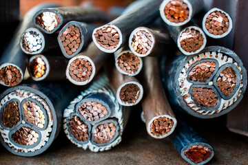 Macro photo of many copper wires twisted into rods and covered with plastic or gum isolation....