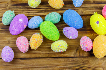 Easter eggs on rustic wooden background. Top view