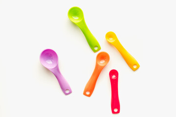 colored measuring spoons on white background, measuring spoons on white background