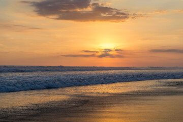 Fototapeta na wymiar Beautiful sunset sky on the beach in Matapalo, Costa Rica. Central America. Sky background on sunset. Tropical sea.