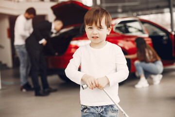 Family with little son in a car salon