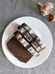 top view of bread on a plate, next to garlic