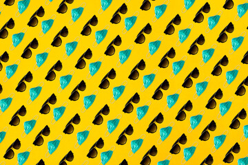 Pattern with medical surgical protective mask and sunglasses on yellow background. Summer vacation during global Coronavirus pandemic concept background