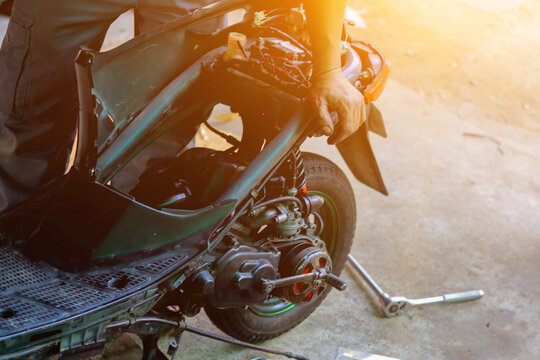 Blurred image,motorcycles repair after a tire leak during a long journey. Modifying some parts of a car when it is used for a certain period of time by an expert technician. motorcycles repair