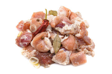Raw pieces of pork shish kebab in marinade with pepper, onion,bay leaf, ready to cook, barbecue meat, isolated on a white background.