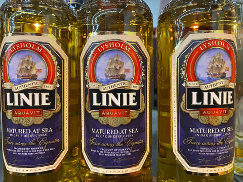 Viersen, Germany - March 1. 2021: Closeup of bottles with lysholm linie aquavit logo lettering in shelf of german supermarket