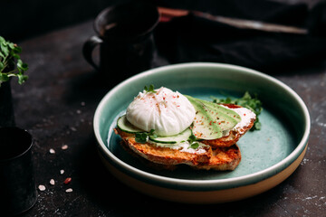 Breakfast. Sandwich with cream cheese, avocado, cucumber and poached egg