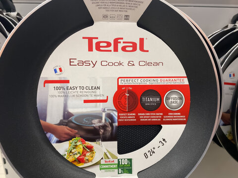 Viersen, Germany - March 1. 2021: Closeup of frying pan with tefal logo lettering in shelf of german supermarket