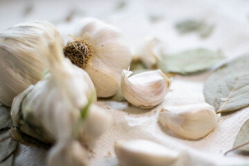 Garlic cloves and flask in a wooden bowl. Healthy eating.