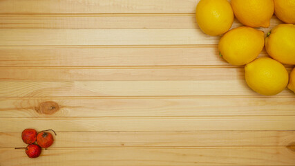 Lemons on a wooden table. View from above. Place for your text. Wooden background.
