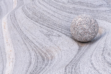 Fototapeta na wymiar Protected stone ball in natural curves with beautiful textures in old granite stone