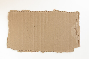 ripped piece of cardboard isolated on white background, cardboard scrap, top view