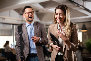 Colleagues in office. Businesswoman and businessman discussing work in office.