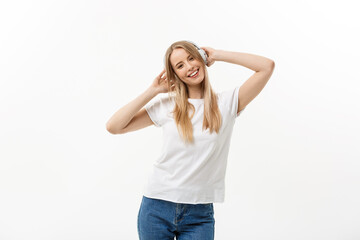 Fototapeta na wymiar Lifestyle Concept: Portrait of a cheerful happy girl student listening to music with headphones while dancing isolated over white background