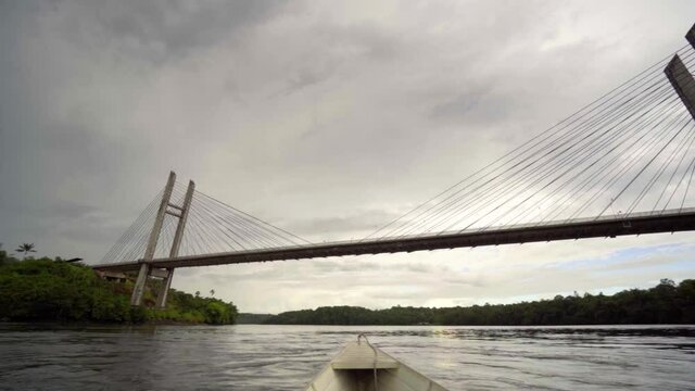 white boat on the oiapoque river amapa amazon brazil rainforest filmed with sony A7iii