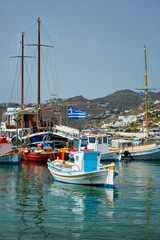 Naklejka na ściany i meble Mykonos port with fishing boats and yachts and vessels, Greece